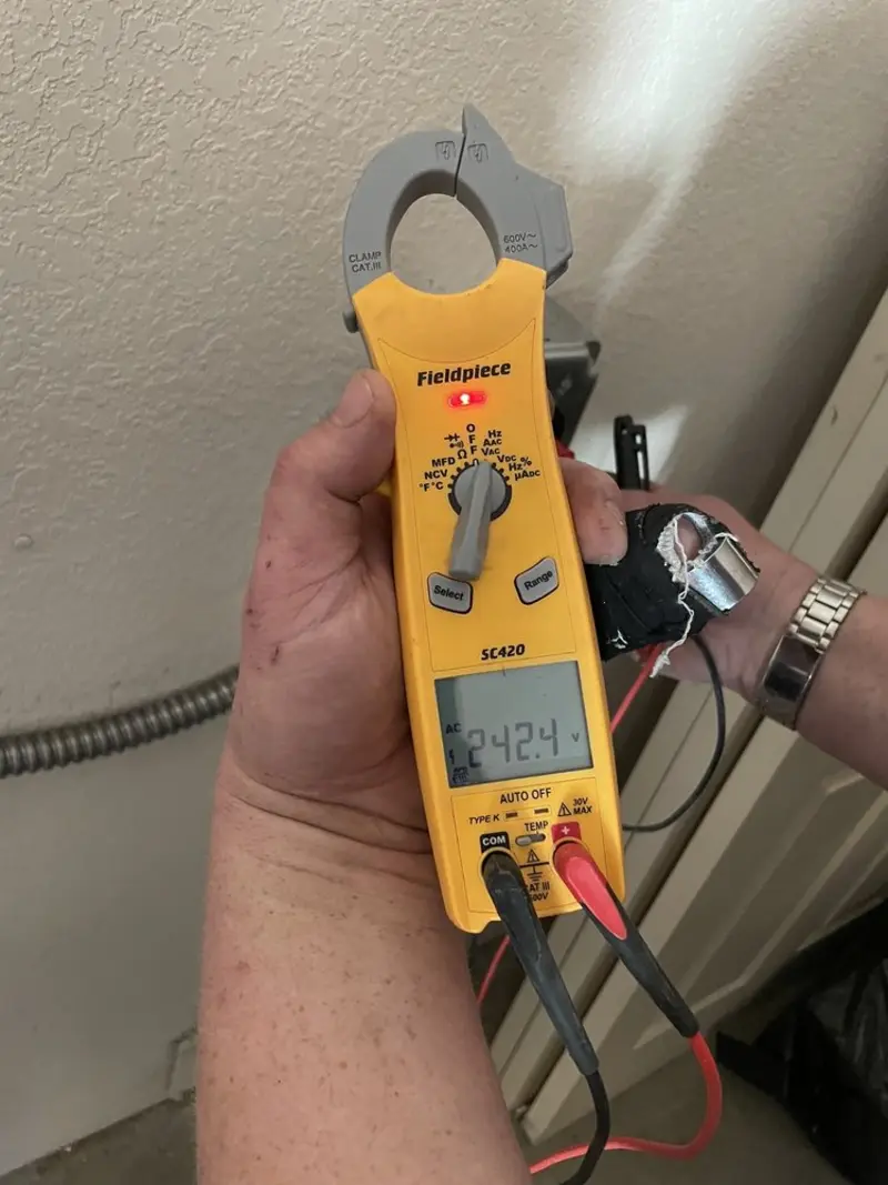 Voltage testing with clamp meter during Whole House Surge Protector in Addison